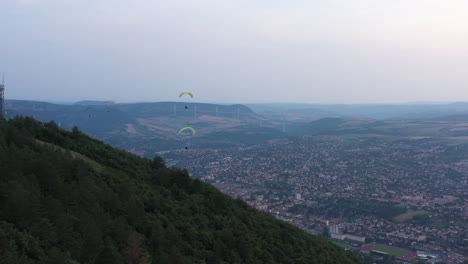 Paragliders-over-the-city-of-Millau-Aveyron-France-cloudy-sunset